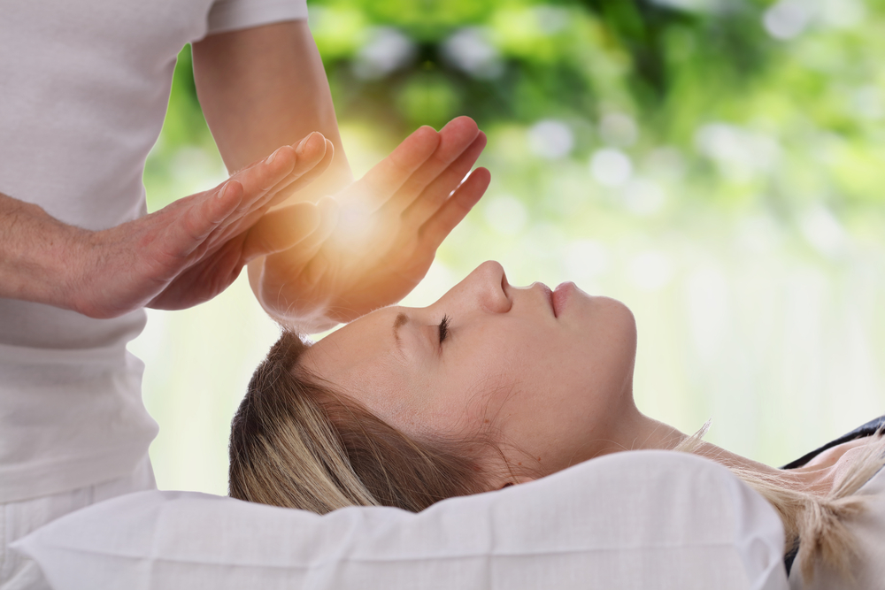 Woman receiving Reiki healing